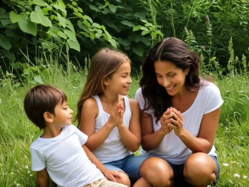 A woman with her two sons in nature, showing them the benefits of mindfulness