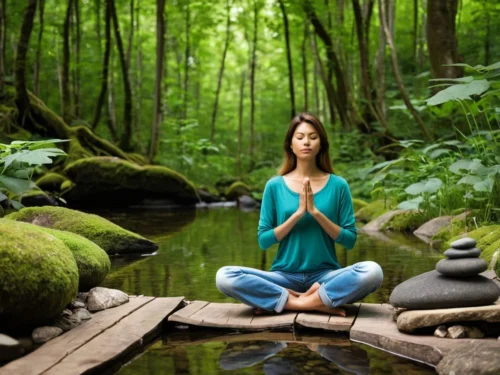 Woman meditating on a rock by a tranquil lake in the forest