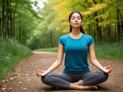 A student practicing mindfulness outdoors in nature, sitting calmly on the grass surrounded by trees and sunlight.