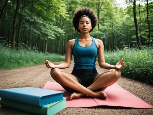A young woman meditating outdoors in a serene natural setting, with two books in front of her