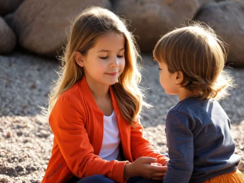 Young sister and little brother meditating together in natural outdoor setting