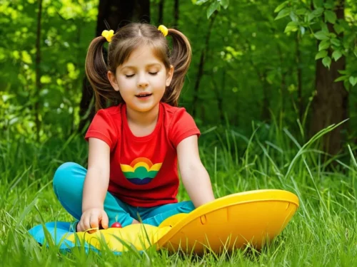 Young girl playing educational mindfulness game outdoors in natural setting