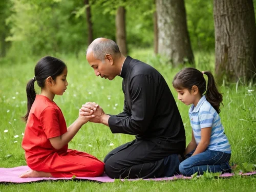Elderly man teaching children prayer and meditation while sitting on the ground surrounded by trees in nature