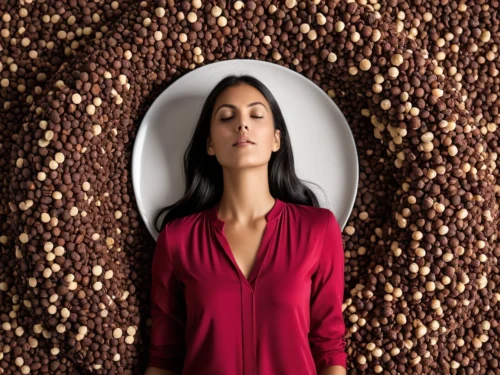 Woman lying on her back with closed eyes on empty plate, illustrating mindful eating and conscious living practices
