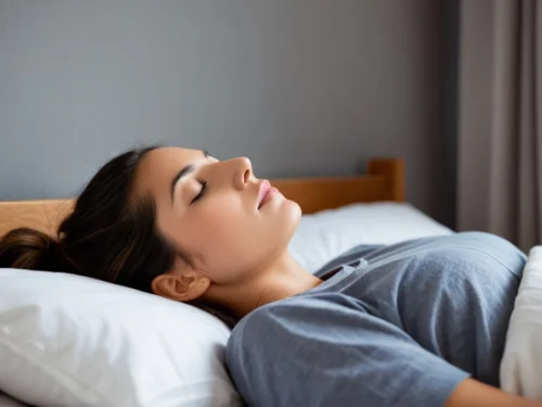 A young woman sleeping peacefully on her bed, showing calm and restful sleep after mindfulness practice.
